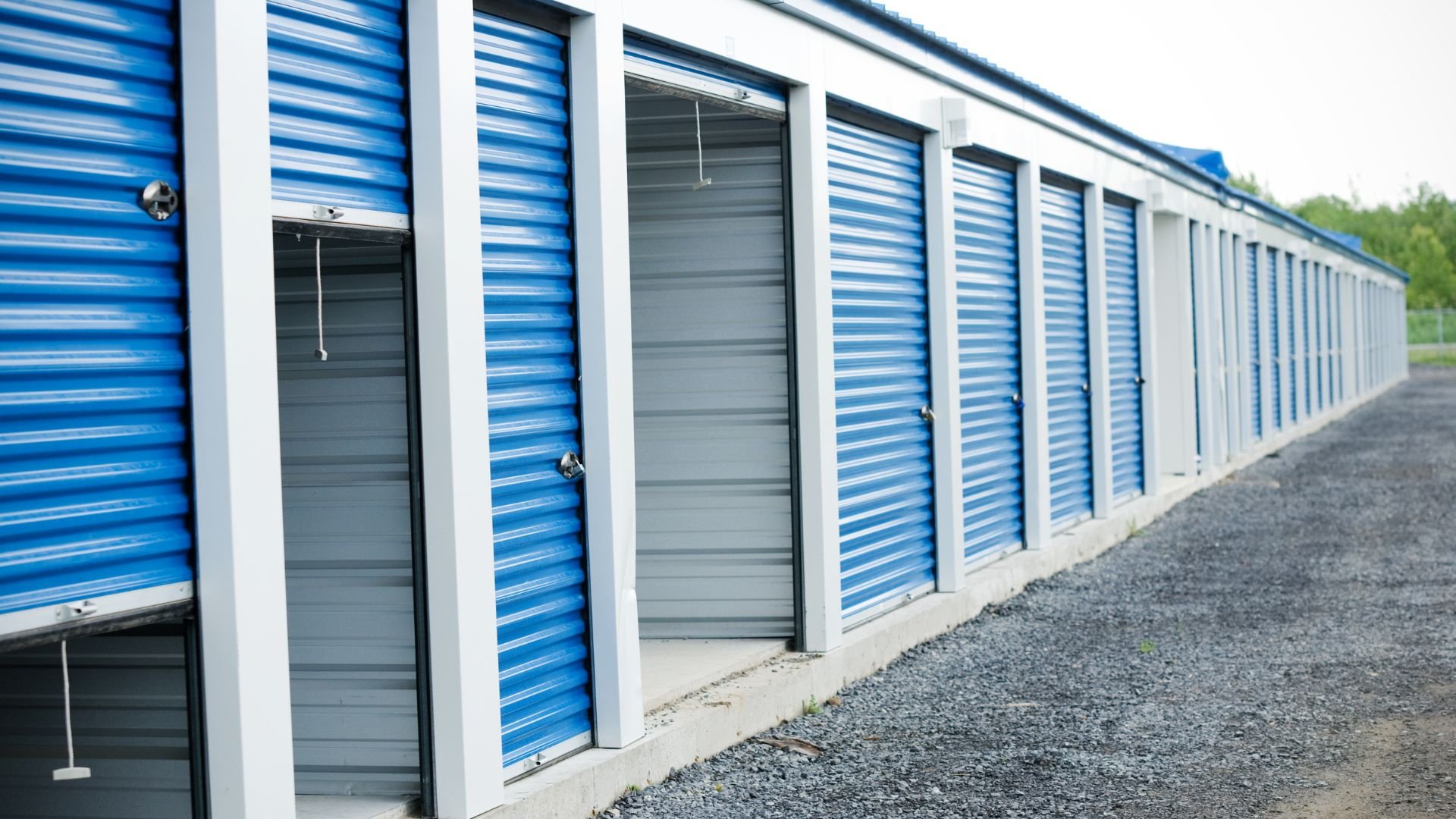 Blue and white storage units with closed doors in a row