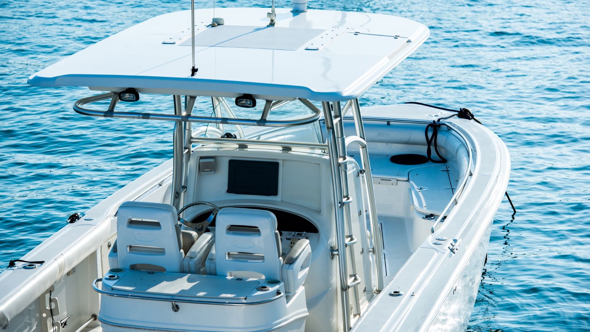 White center console boat with hardtop on blue ocean water
